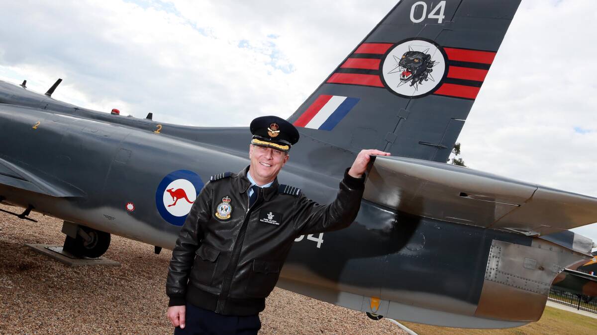MILESTONE: RAAF Wagga's Base Commander Group Captain Chris Ellison with a vintage aircraft at the base. Picture: Les Smith