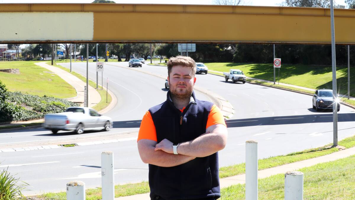 SPLASH OF PAINT: Wagga's Jacob O'Hare stands near the rail overpass on Edward and Tarcutta streets, which he believes should be used for public artwork. Picture: Emma Hillier