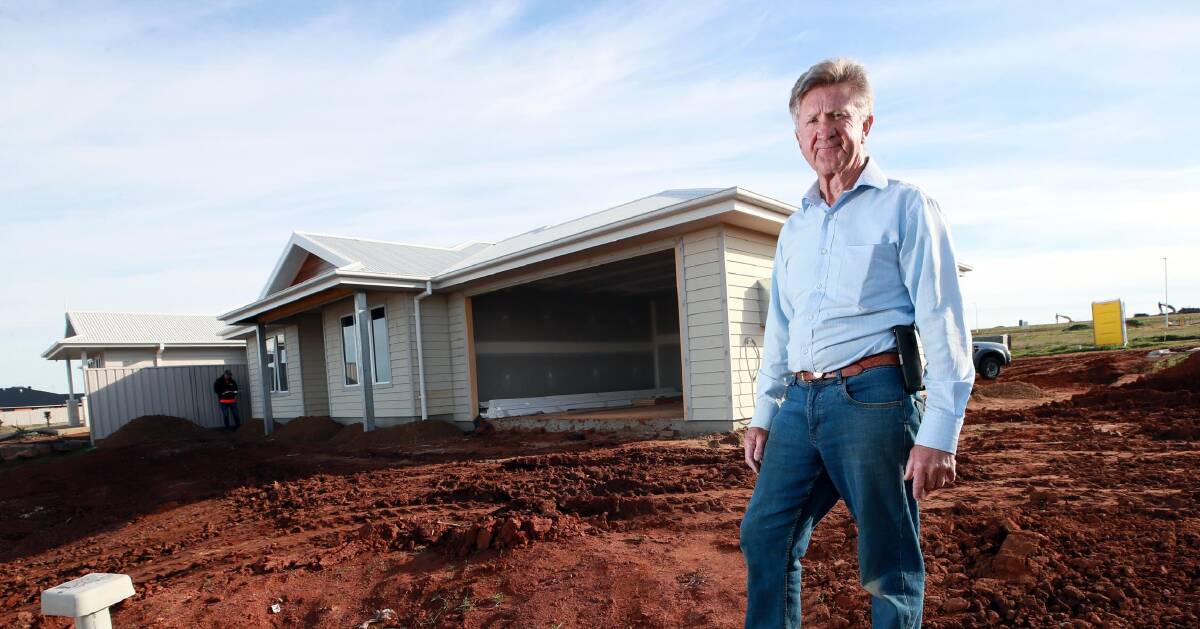 Builder Wayne Carter standing outside one of the homes currently under construction. Picture: Les Smith
