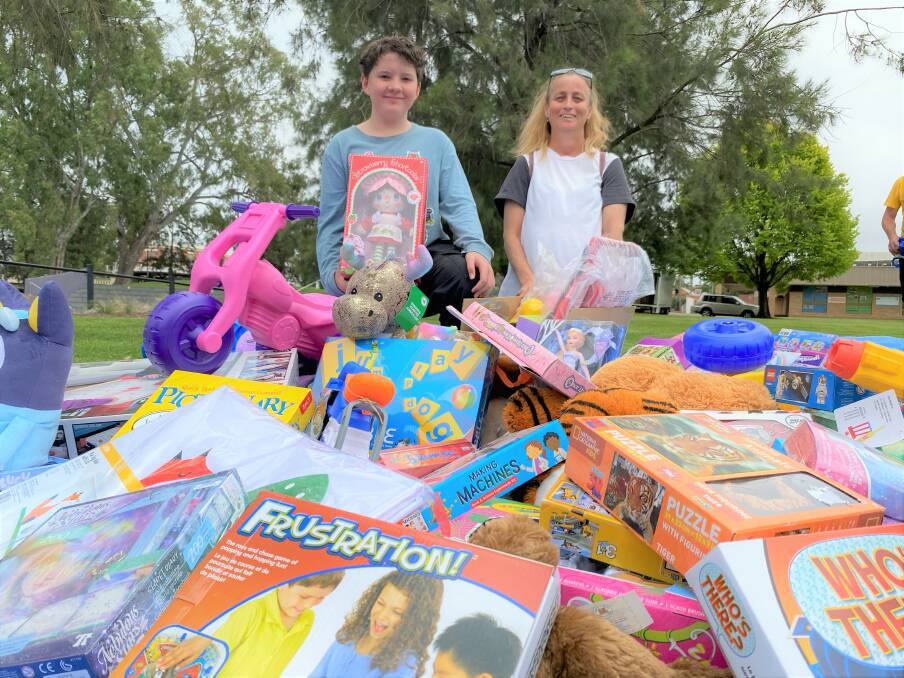 SPREAD THE CHEER: Wagga's William Goldstraw who raised more than $200 worth of toys and committee member Peta Gerhard with just some of the donations this year. Picture: Daina Oliver 