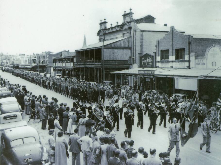 1952 Anzac Day March: Standard Bearers Flag Party, Les Pratt (left) and Jack Dunn, Secretary of the Wagga sub-branch, followed by the Wagga Citizens Band. The front row of marchers, left to right, are David Sheppard (a Boer War veteran), Captain Reg Saunders MC (the only Aboriginal officer in the Australian forces and the guest speaker in 1952, (A L Baker, president of the Wagga sub-branch and Les Barrand, MM. Photo: Sherry Morris Collection
