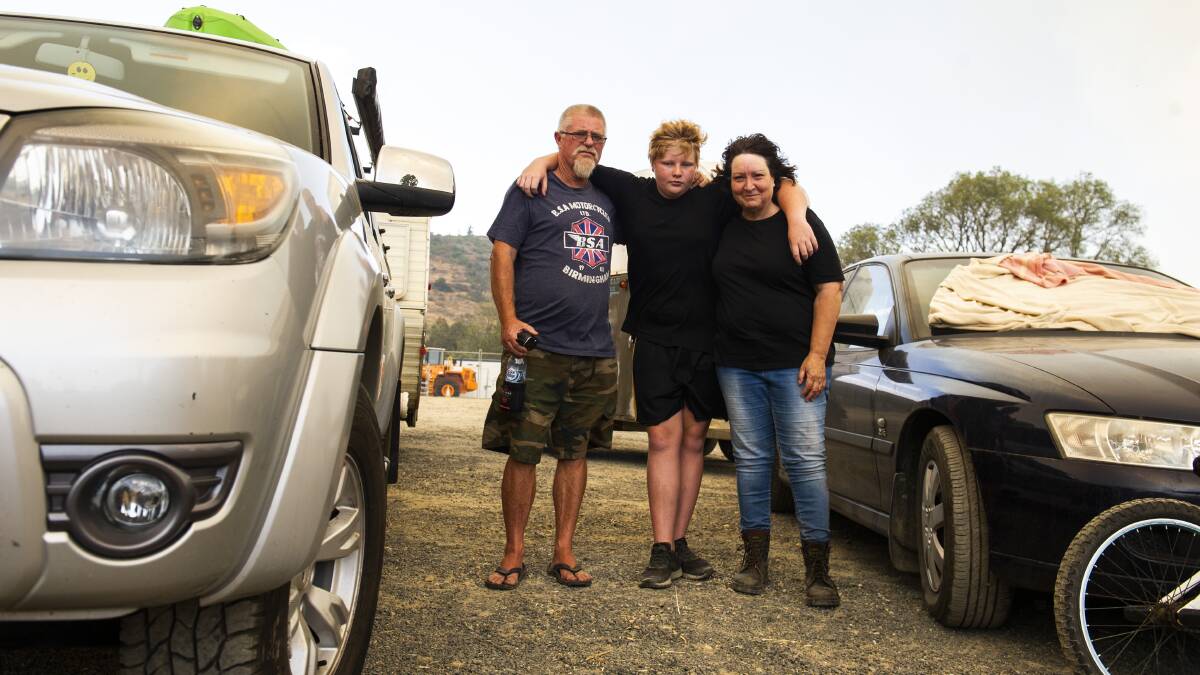 Adelong residents Mick Nichols, Cooper Nichols, 13, and Beatrice Markham intend to stay in the town despite fires threatening it. Picture: Dion Georgopoulos