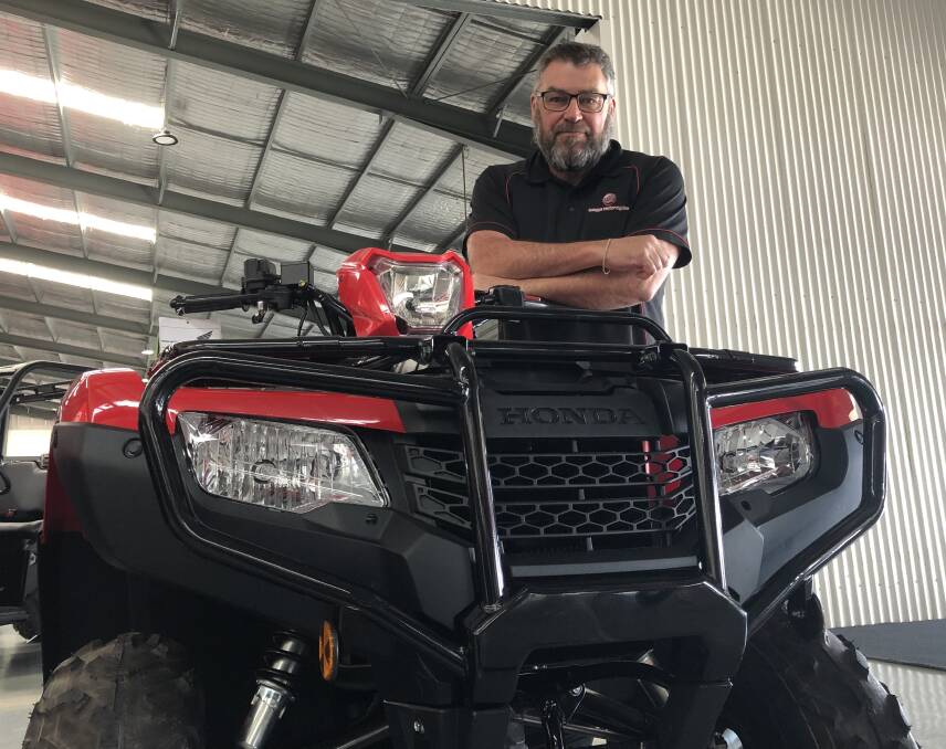 Wagga Motorcycles sales manager Andrew Stemp, with one of the Honda quad bikes still in stock. Picture: Jody Lindbeck