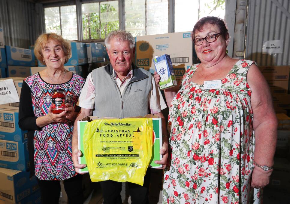 Joanne Crowley (right) with fellow St Vincent de Paul volunteers Josie Howard and Trevor Urquhart preparing for the 2017 Christmas food appeal in Wagga.