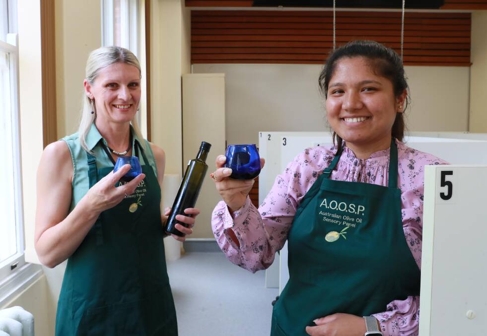 THE GOOD OIL: Belinda Taylor and Rojina Maharjan from the Department of Primary Industries take a closer look at some olive oil samples. Picture: Les Smith