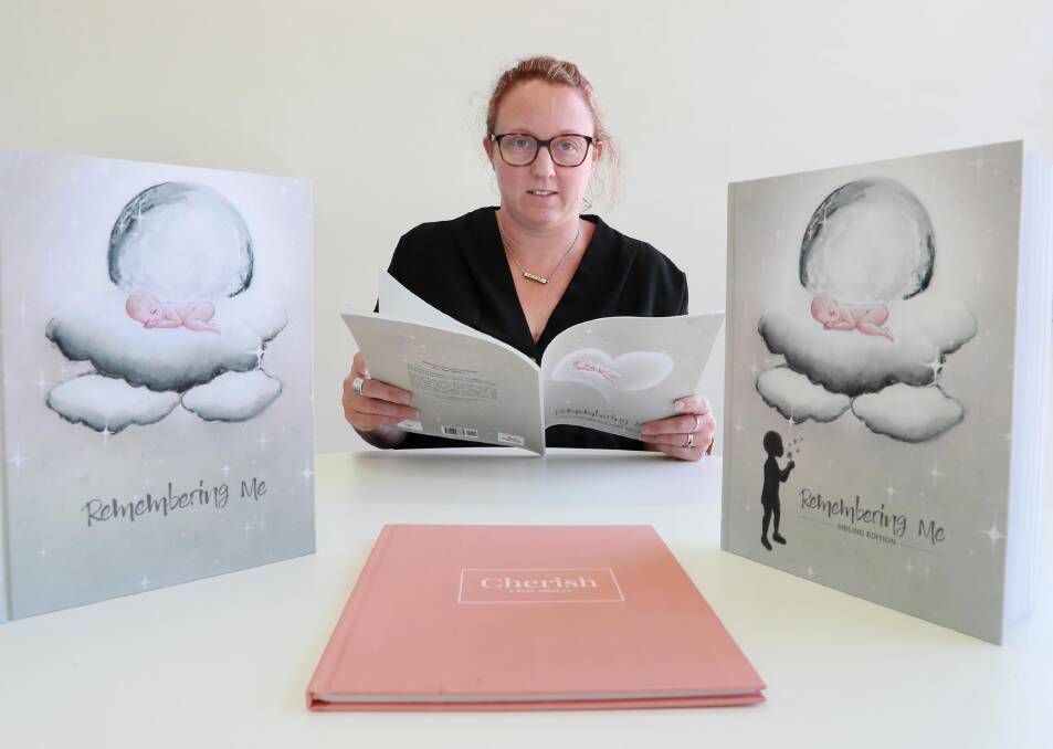 Wagga graphic designer Shaela Mauger with the special memory books she has created.