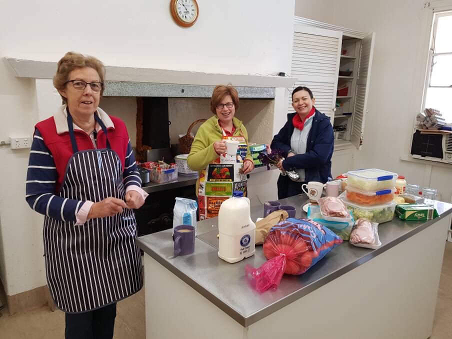 Joy McInnis, Jane Lieschke and Rachel Whiting hard at work in the kitchen ahead of an event.