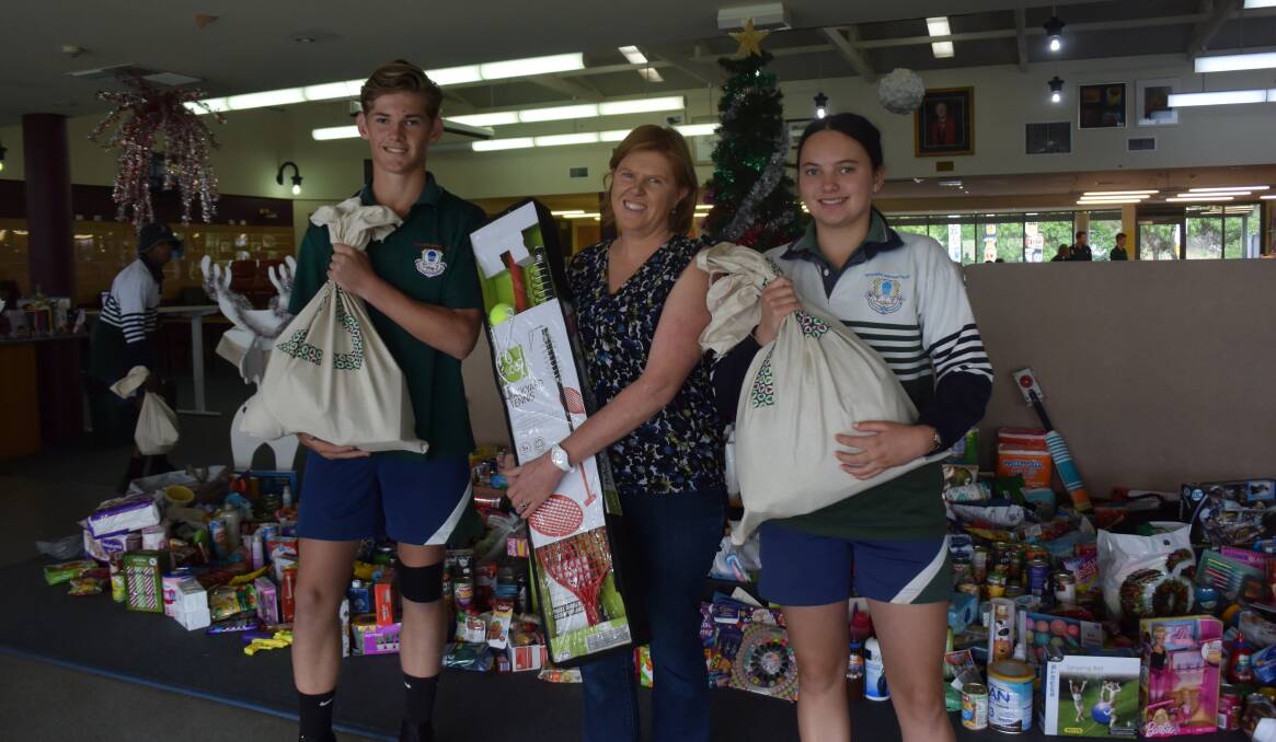 DONATION: Students from The Riverina Anglican College Jarrod MacLeod and Lara Jay with Kristy Daley from Anglicare. 