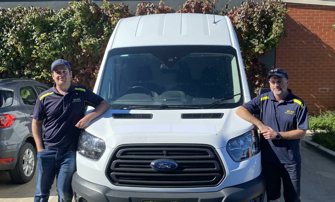 MLHD patient transport officers Ben Thompson and Ian McDougall with the mobile testing van.