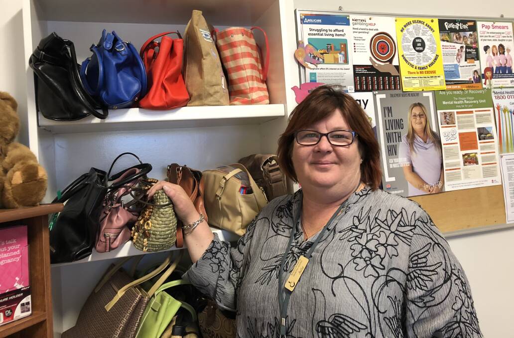 HELPING OUT: Julie Mecham of the Wagga Women's Health Centre with some of the handbags filled with personal items that have been donated. Picture: Jody Lindbeck