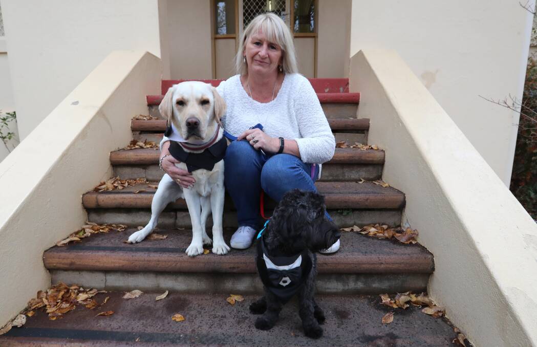 Robyn Catmull-Harding of The Bidgee School with therapy dogs Humphrey and Casper. Pictures: Les Smith