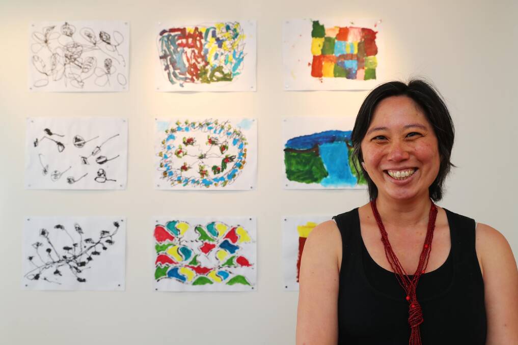BLENDED TALENTS: Wagga physiotherapist and artist Lieng Lay with some of the works created during the Painting with Parkinson's program. Picture: Emma Hillier