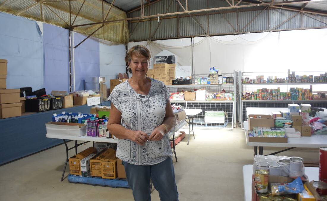 Jenny Blanch with some of the thousands of items of food and toiletries donated to keep the BlazeAid camp running.