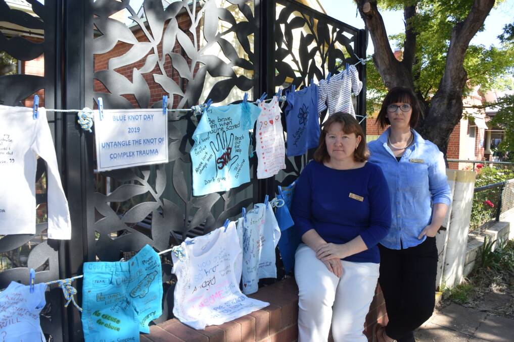 SURVIVORS' EXPERIENCES: Leah Anderson and Emma Creasy with the display outside the Wagga Women's Health Centre in Peter Street to mark Blue Knot Day, a recognition of childhood trauma. Picture: Jody Lindbeck