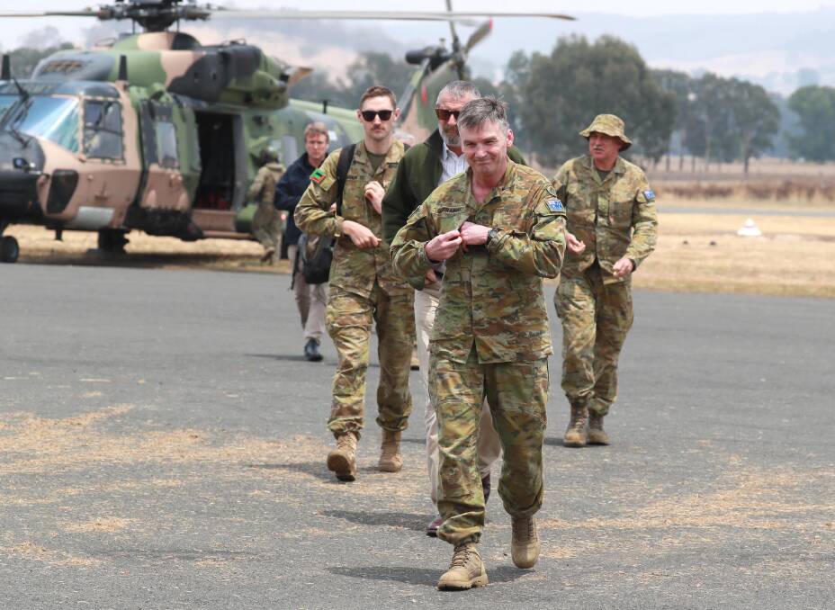 TOURING REGION: Brigadier Mick Garraway and other defence and recovery effort personnel arrived in a military MRH-90 helicopter.