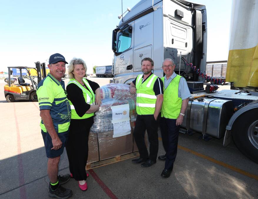 SPECIAL DELIVERY: Danny Miller of Ron Crouch Transport, Rotarian Marilyn Roberts, Jeff Roworth from Ron Crouch Transport and Rotarian Gary Roberts, with the water filtration pumps. Picture: Kieren L Tilly