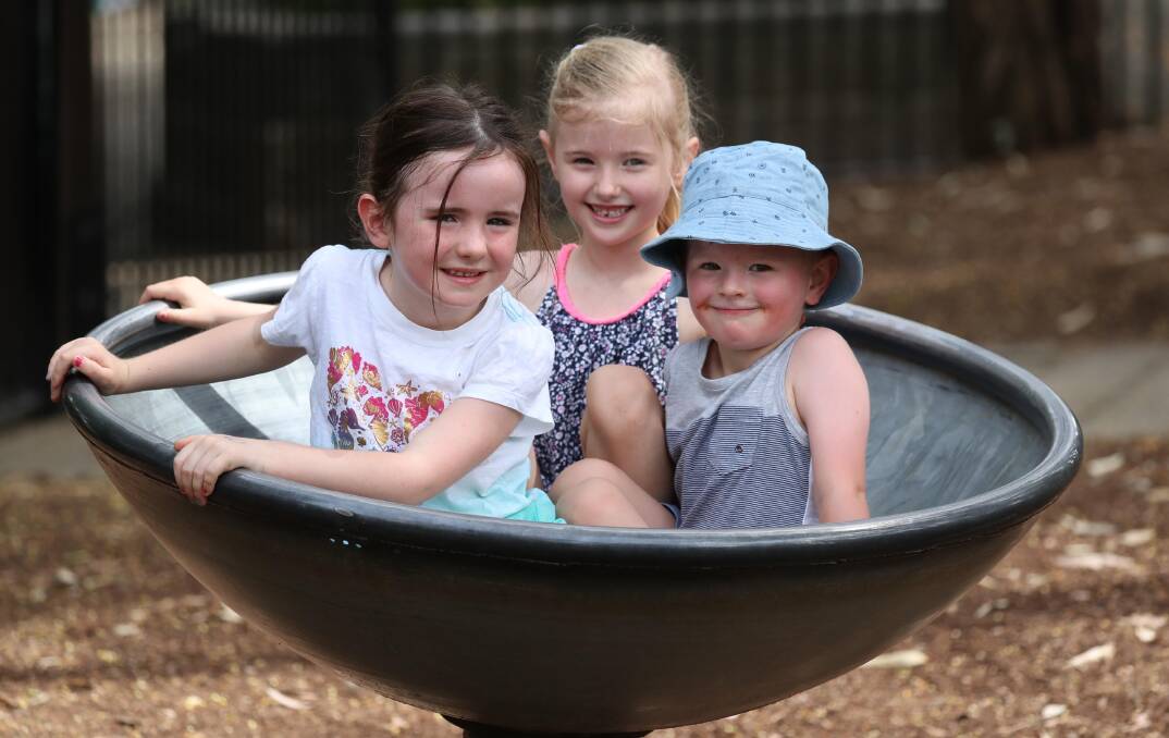 SHADY SPOT: Lillian McKenzie, 5,  Asha Forrell, 6, and Eli Forrell, 3, found a shady spot in the Wagga Botanic Gardens. Picture: Les Smith
