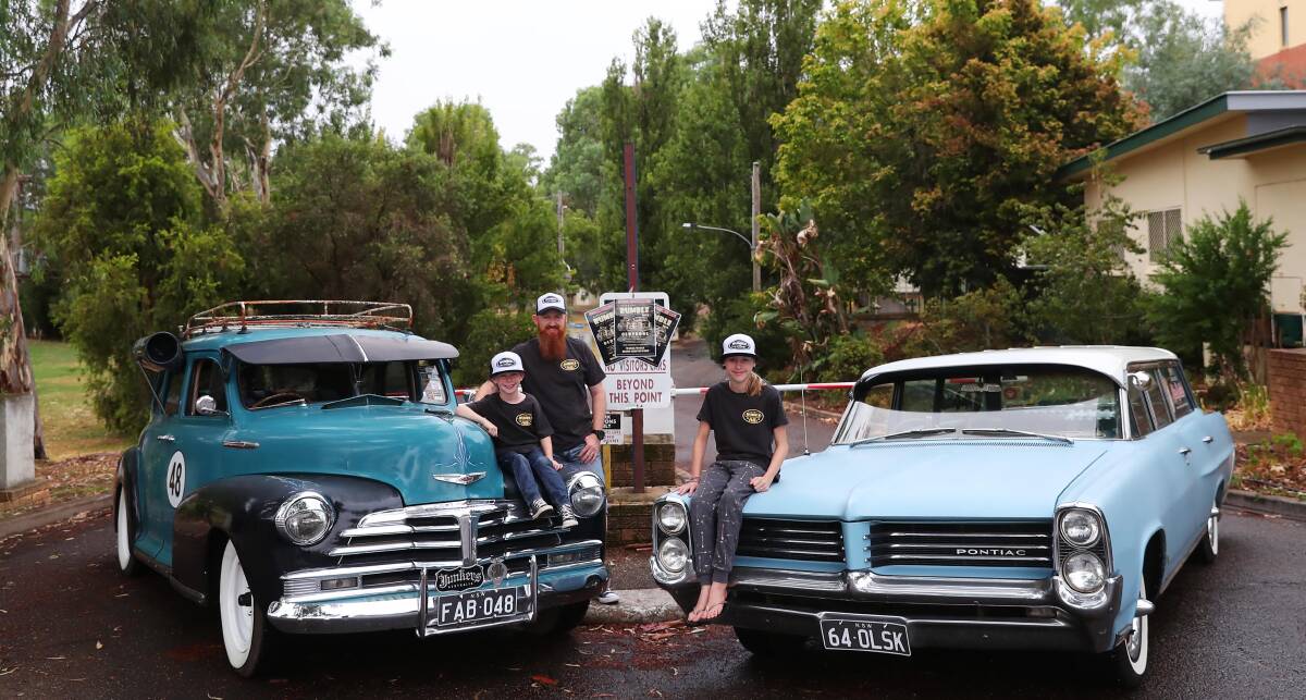 REVVED UP: Riverina Rumble organiser Howard Brown, with son Spencer, 6, and daughter Felicity, 12,with their 1948 Chevy and 1964 Pontiac. Picture: Emma Hillier