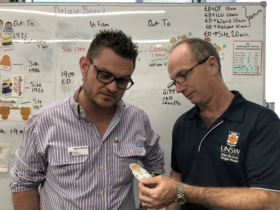 PATIENT ASSESSMENT: Wagga Base Hospital's Mitch Woods and Stephen Wood assess a "patient" during the mock disaster training exercise.