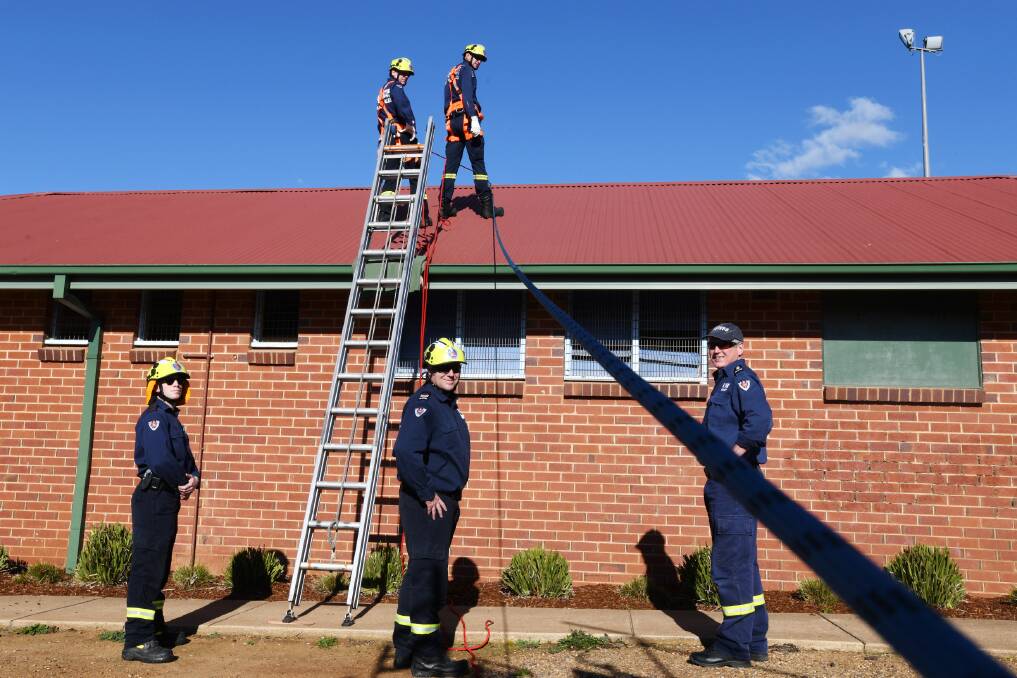 UP ON THE ROOF: Firefighters Liam Kelso, Lee Hyde, David Simpson and Joel Sims train with Station Officer Daniel Humphrey (right).