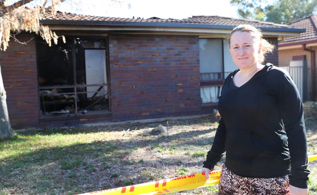 Rebecca Evans outside the gutted property of her neighbour.