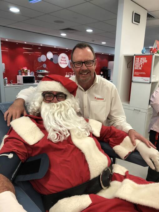 Wagga Donor Centre manager Neil Wright chats with Santa Clause, who dropped in to make a donation.