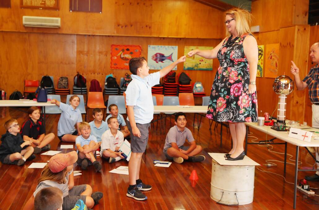 ZAP: Ashmont Public School student Mathue Dent, 10, get a hand-on lesson in static electricity after being "zapped" by Tarcutta Public School teacher Kirrilee Post. Picture: Kieren L Tilly