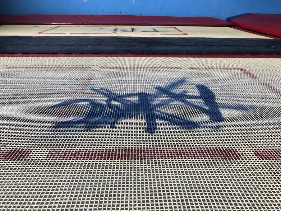 The graffiti on on the woven trampoline nets.