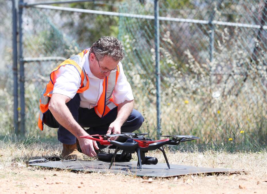 Neville Shepheard from Telstra, a CASA-licensed pilot, with his company Solo 3DR drone.