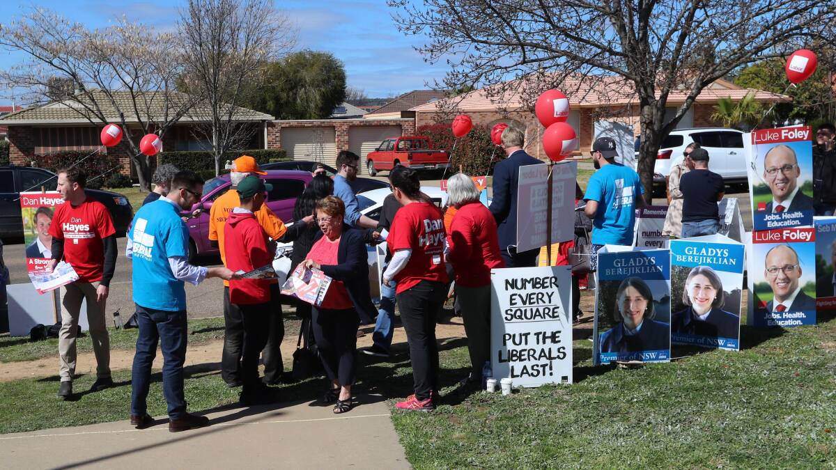 Colourful scenes as volunteers share how-to-vote cards with Wagga voters.