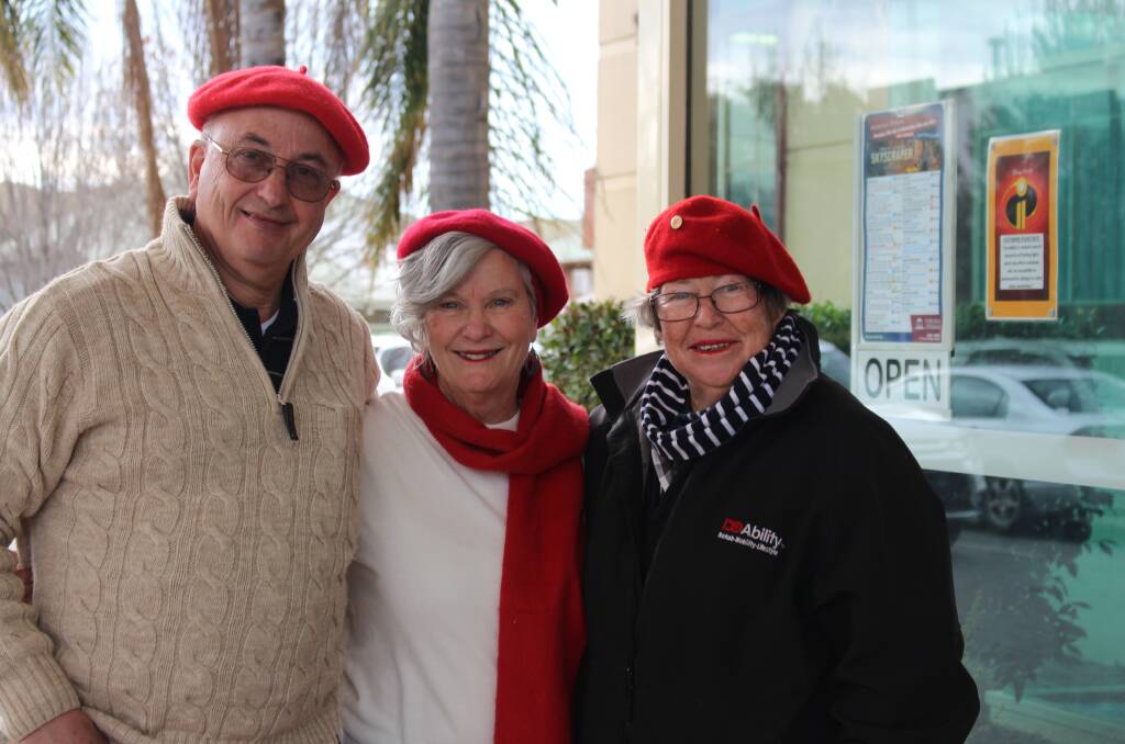 Sally Taylor, right, promoting the Alliance Française de Wagga film festival with Graham and June Pack.