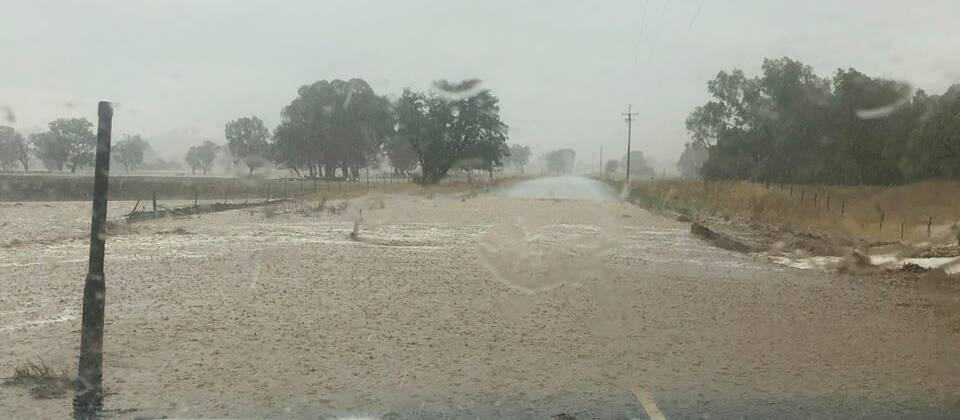 STORMY WEATHER: Flash flooding at Tumblong, where the threat of bushfire has remained high for at least three weeks, as bushfires swept through the Snowy Valleys. Picture: Jake Smith