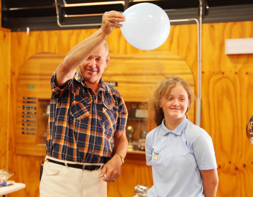 CLINGY: Peter Eastwell of Science Time demonstrates the effect of static on Chloe Griffiths from Ashmont Public School.