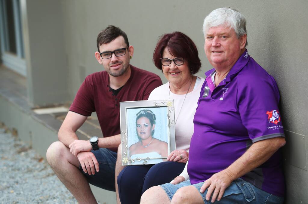 Tim, Annette and Peter St Clair with a photo of sister and daughter, Amie.
