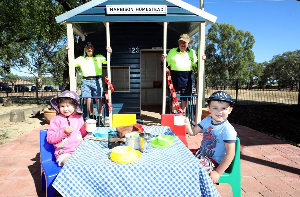 OPEN FOR PLAY: John Stubenrauch and Peter Quinane from the Wagga Men's Shed with Michaela Johansen, three, and William Walsh, four. Picture: Les Smith