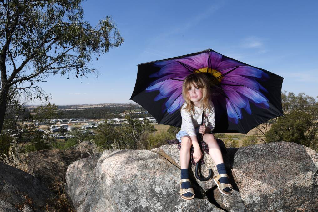 RAIN PREDICTED: Hazel Matikainen, 4, might be using that umbrella to stay out of the sun, but by the weekend, it could be warding off rain.