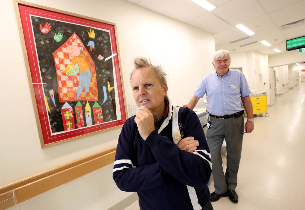 Wagga Base Hospital patient Mark Janetzki and geriatrician Paul Finecane admire an artwork by Andrew Totman.