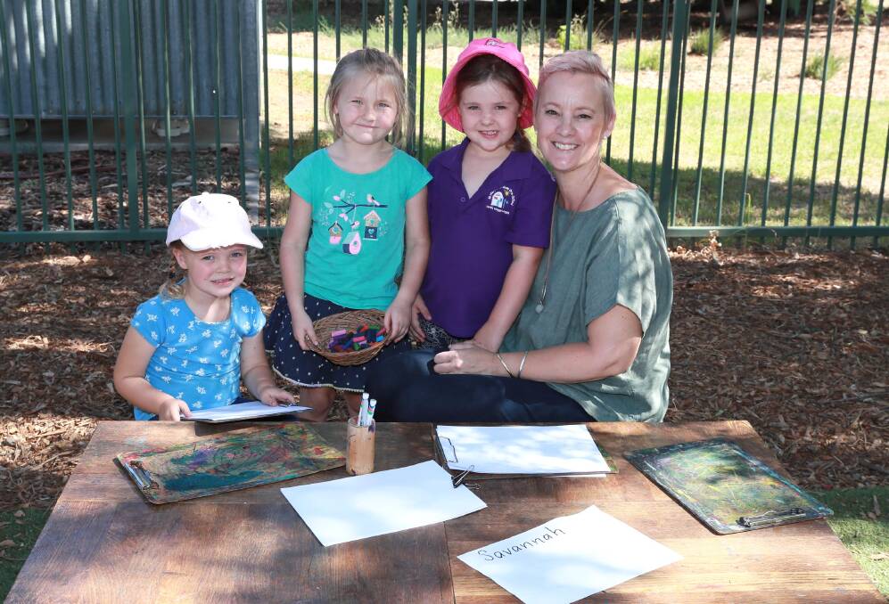 HOLISTIC CARE: While the main focus is the children, St Mary's Rainbow Preschool director Sharon Gill, says staff care for the whole family. With Ms Gill are Josie Brown, 3, Bridget Gow, 5 and Emily Crocker, 5, Picture: Les Smith