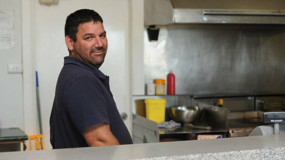 END OF AN ERA: Brendon Marcanio stands behind the counter at the soon to close Bilbul Store near Griffith. 