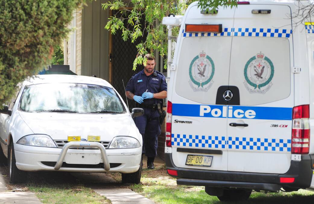 Police at the Chifley Crescent property where an alleged serial home invader was arrested. 