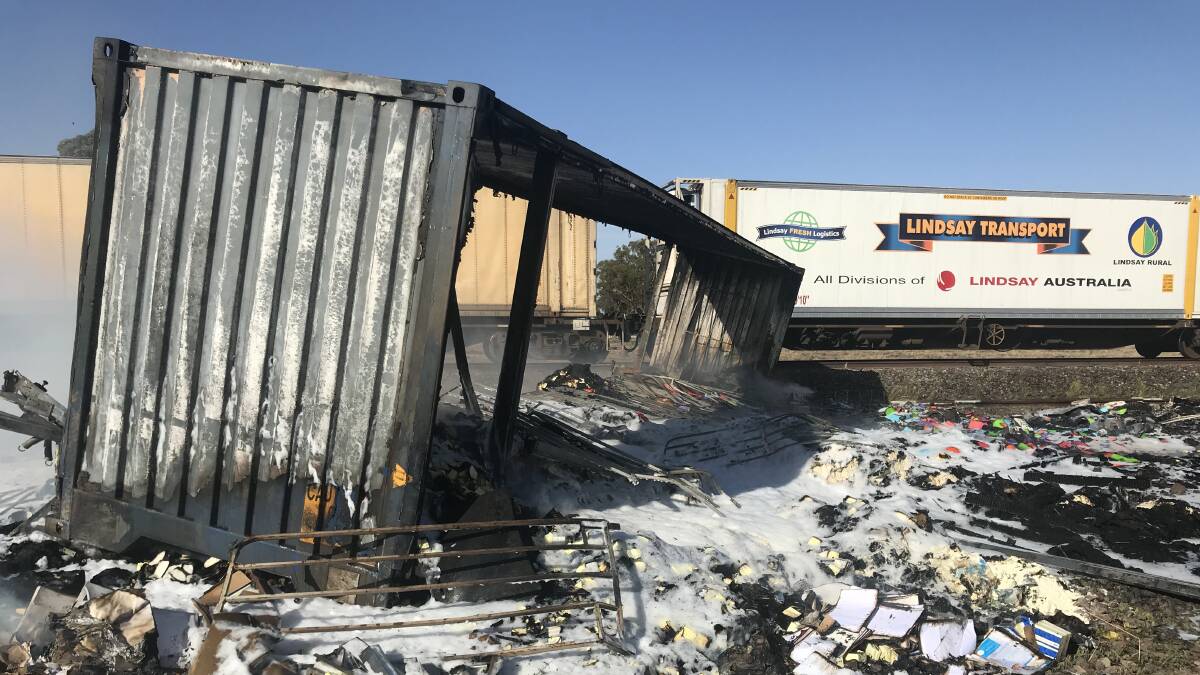 A container was dislodged and sparked a paddock fire following a collision between a truck and freight train at the level crossing on the Mary Gilmore Way near Bribbaree on Tuesday morning. Photo: contributed