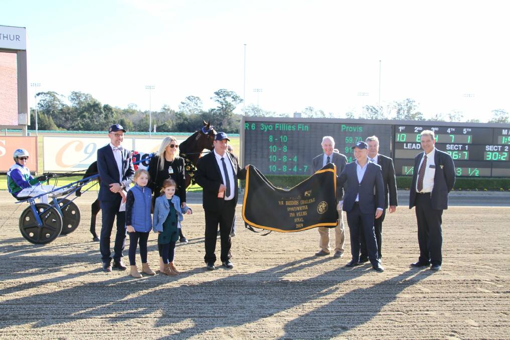 Heavily involved: Alabar general manager Brett Coffey (far left standing) at Menangle earlier this month. Alabar is sponsoring this year's Breeders Challenge.