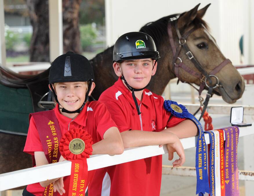 Winners are grinners: Henry McClintock, 14, and Michael Payne, 14, competed successfully at this year's Sydney Royal Easter Show in the mounted games section. Picture: Laura Hardwick.  