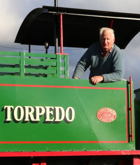 Big toys: Peter Neve OAM in one of his trains when it was being delivered to his Junee property. 