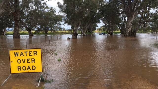The road had a sign warning drivers of the water danger. 