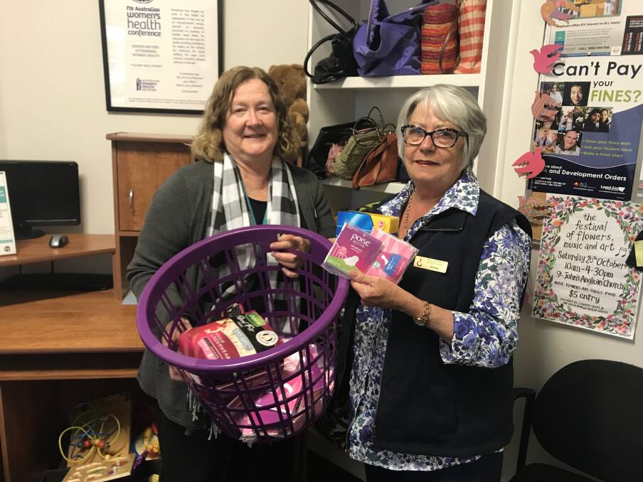 ABOUT TIME: Gail Meyer and Jenny Jordan from Wagga Women's Health Centre are holding up feminine sanitary products that will soon be tax free. Picture: Jess Whitty