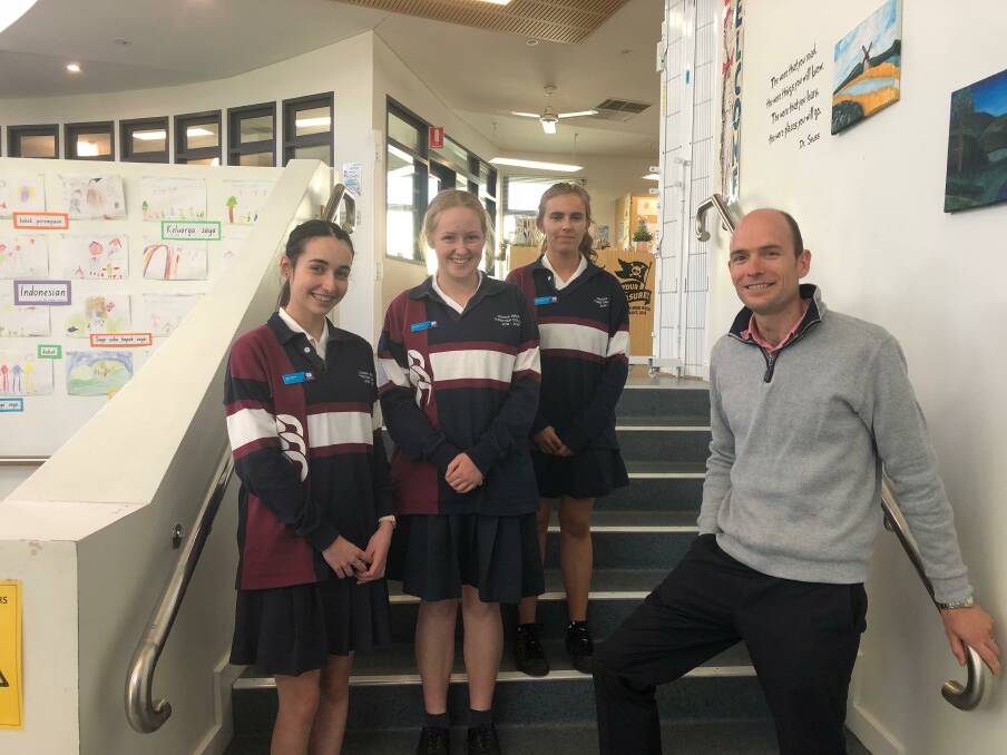 BOSS CHALLENGERS: Wagga Christian College Year 11 students Leah Hector, Ella Bergmeier, Paige Burkinshaw with their business teacher Stephen Gilmour. Picture: Jess Whitty