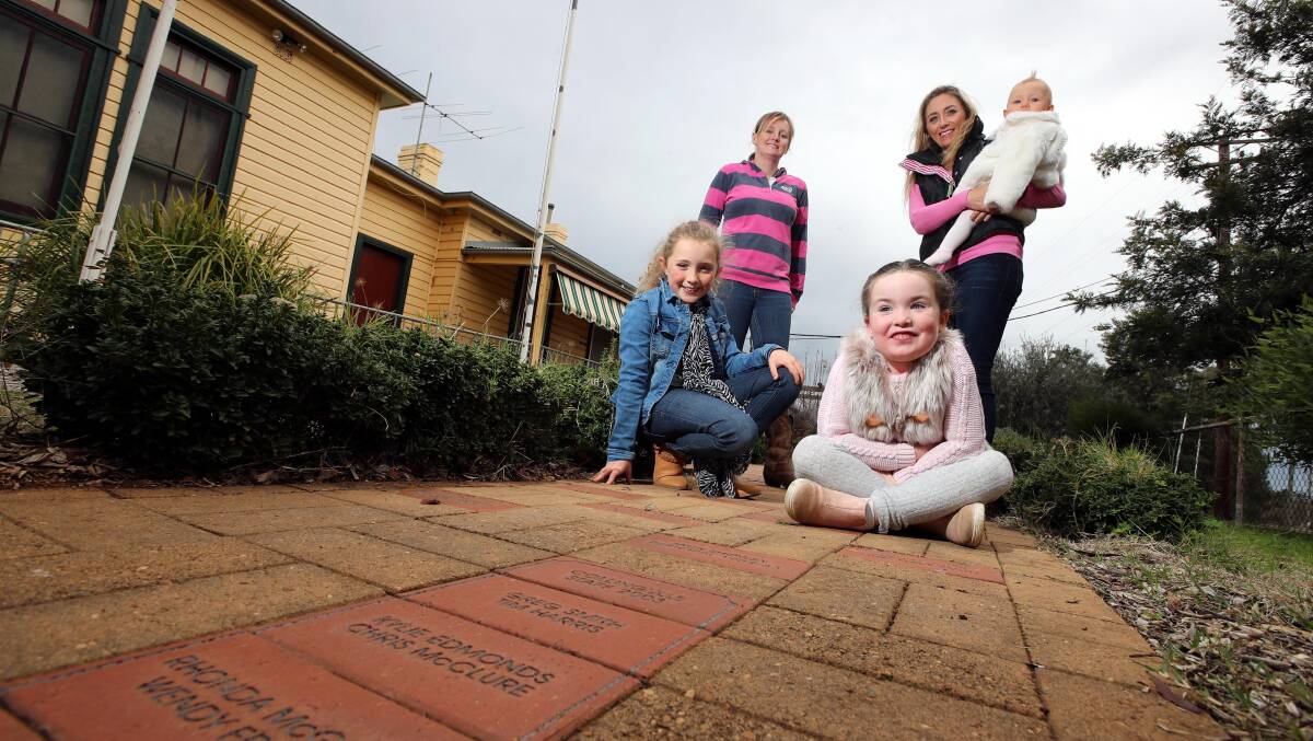 BANDING TOGETHER: Collingullie residents (FL) Kilarny Trethowan, 8, Pippa Lisle, 6, (FR) Vicky Lisle, Sara Jones and Summer Jones, 10 months, fighting to save the school. Picture: Les Smith