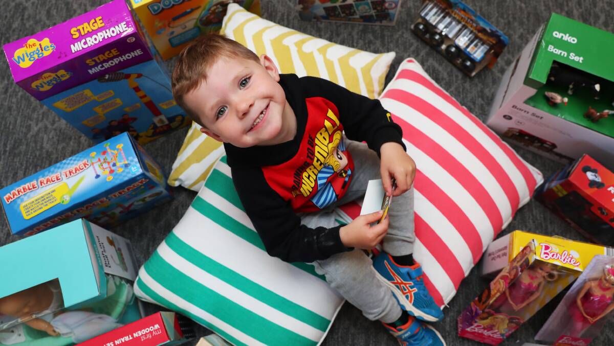 HELPING OTHERS: Lake Albert Community Kids preschooler Lewie Harmer, 3, surrounds himself with toys donated by his class to children at the Ronald McDonald House. Picture: Emma Hillier