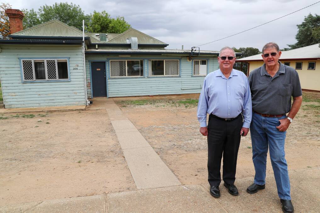 FINAL FAREWELL: Brothers Athol and Peter Price visit their childhood home one last time before 18 cottages on Village Way are demolished. Picture: Emma Hillier